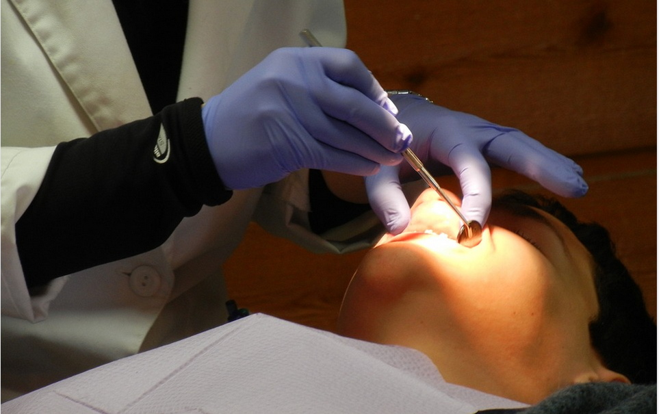 a cosmetic dentist attending a patient